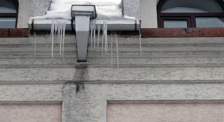 Large icicles hanging from Ohio home roof gutter