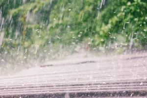 Hail striking residential roof during storm
