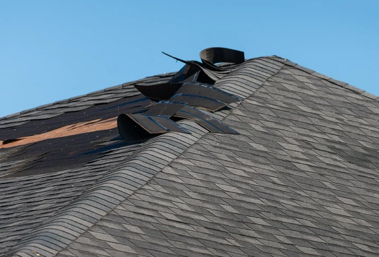Roof edge shingles lifted by wind